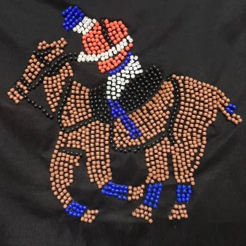 Allover computerized beading embroidery with a cowboy-on-horseback motif